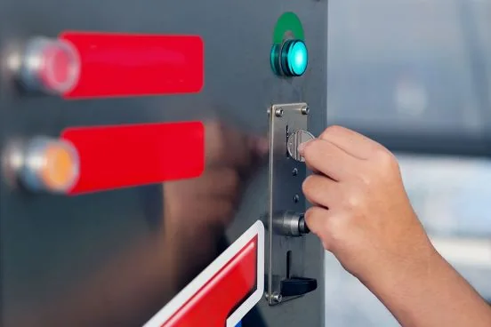 Customer inserting a coin into an automatic vending machine
